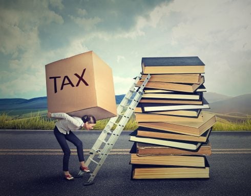 Tax Debt Concept. Woman With Heavy Box Full Of Tax Debt Carrying