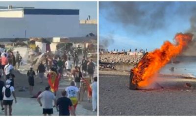 watch:-protesters-hoist-spanish-flag-after-storming-beach-and-torching-migrant-camps-in-ceuta