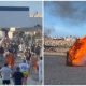 watch:-protesters-hoist-spanish-flag-after-storming-beach-and-torching-migrant-camps-in-ceuta