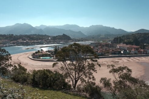 A beach in Ribadesella with surrounding mountains