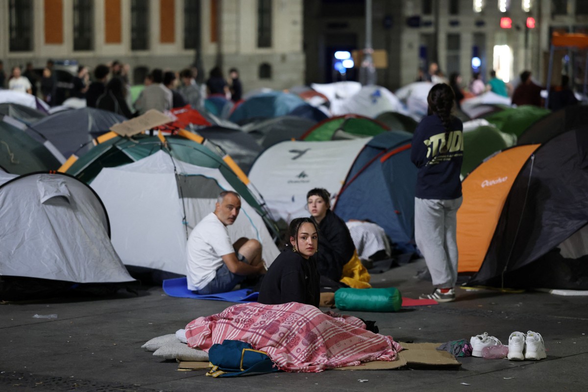 Demonstrators wake up as they camp with tents one day after a protest against evictions and the housing crisis in front of the Presidency of the Community of Madrid on the Puerta del Sol plaza in Madrid