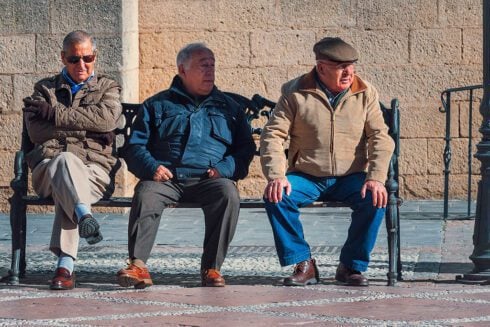 Spanihs Pensioners sitting down at a bench