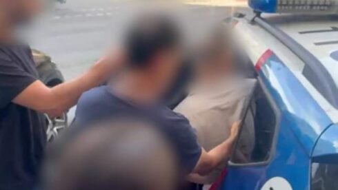 A blurred image of a man being arrested the mossos d' escuadra in Barcelona