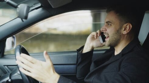 A man on a mobile phone while driving
